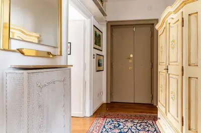 a room with a hallway with a door and a rug at Vatican Almond Tree Penthouse in Rome