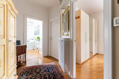 a room with a hallway with a rug on the floor at Vatican Almond Tree Penthouse in Rome
