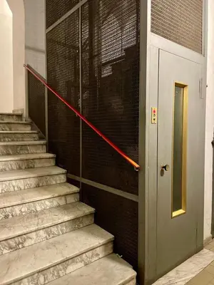 a set of stairs with a red rope next to a door at Domus Gaia in Rome