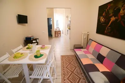 a living room with a white table and a couch at Alloggio Machiavelli 59 in Rome