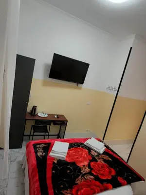 a bedroom with a bed and a tv on the wall at RATTAZZI ROMA CENTRo in Rome