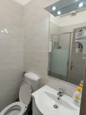 a white bathroom with a toilet and a sink at RATTAZZI ROMA CENTRo in Rome