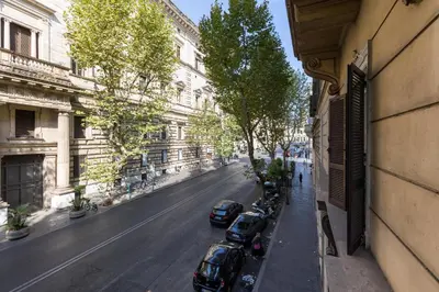 a city street with cars parked next to a building at Merulana 43 - Guest House in Rome