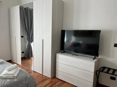 a flat screen tv sitting on a dresser in a bedroom at ALGA Roma in Rome