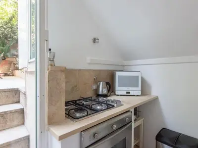 a kitchen with a stove top oven next to a window at Central Station Enchanting Apartments in Rome