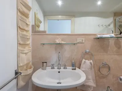 a bathroom with a white sink and a window at Central Station Enchanting Apartments in Rome