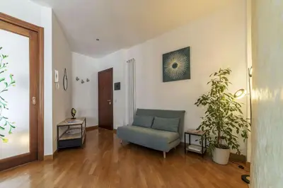 a living room with a blue couch and a plant at HospitalityRome Nice Apartment in Rome