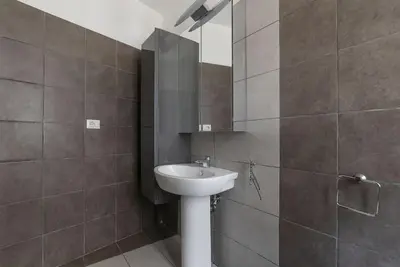 a bathroom with a sink and a mirror at HospitalityRome Nice Apartment in Rome