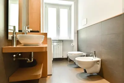 a bathroom with a sink and a toilet at Nerhome Vatican Suite in Rome