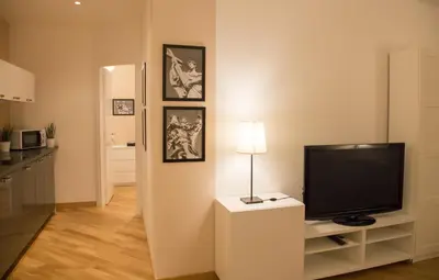 a living room with a flat screen tv on a stand at Nerhome Vatican Suite in Rome