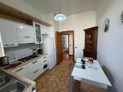 a kitchen with white cabinets and a white counter top at Casa Gigi al Vaticano in Rome