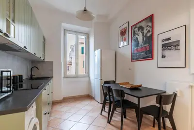 a kitchen with a table and chairs in a room at GuestHost - Lungotevere central and bright apartment in Rome