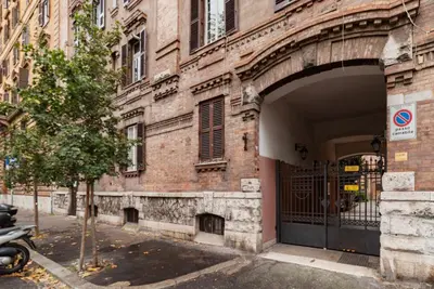 an entrance to a brick building with a gate at GuestHost - Lungotevere central and bright apartment in Rome