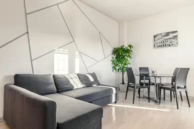 a living room with a couch and a table at Eur-motagnola attico 2bedr apt 280 terrace view in Rome