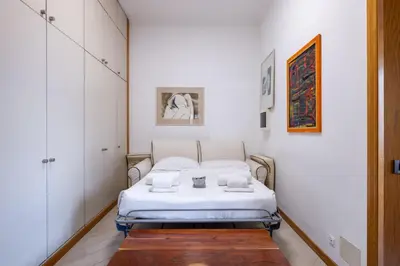 a small bedroom with a bed in a room at Quattro Fontane 2P - B&D Apartments in Rome
