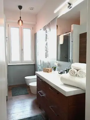 a bathroom with a sink and a toilet and a mirror at Soraya Home in Rome
