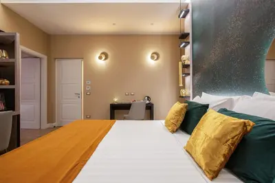 a large bed in a room with a desk at VentiSettembre Private Suites in Rome
