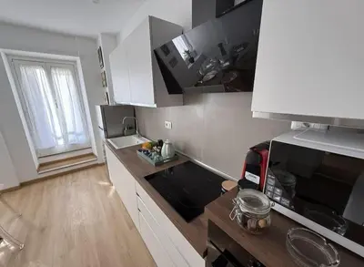 a kitchen with a sink and a counter top at Colosseo Licia Apartment in Rome