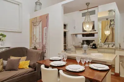 a living room with a table and a couch at Vicolo Savelli Luxury Suites in Rome