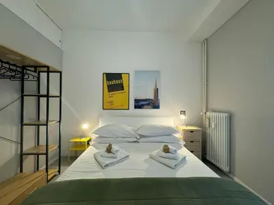 a bedroom with a large white bed with two pillows at Urban Oasis Near Appia Antica Park in Rome