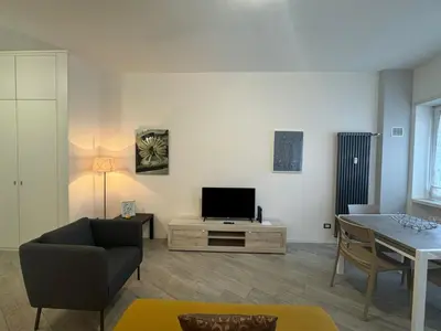 a living room with a television and a table at Urban Oasis Near Appia Antica Park in Rome