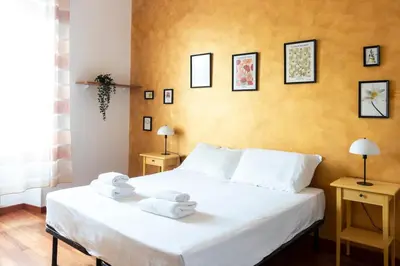 a bedroom with a white bed with towels on it at colosseo view apartment in Rome