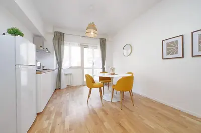 a kitchen and dining room with a table and chairs at Nature Flat in Rome