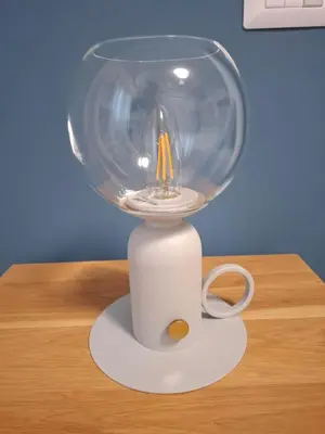 a glass vase with a candle in it on a table at Gardenie House in Rome