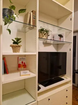 a white book shelf with potted plants on it at casa a PortaPortese in Rome