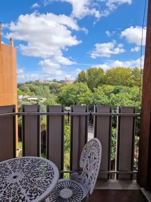 a table and chairs on a balcony with a view at casa a PortaPortese in Rome