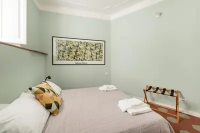 a bedroom with a bed and a picture on the wall at Iside Apt at Colosseum -2 bedrooms 2 bathrooms in Rome