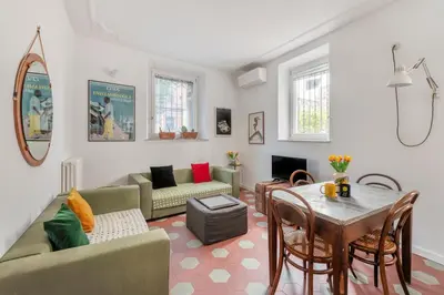 a living room with a couch and a table at Iside Apt at Colosseum -2 bedrooms 2 bathrooms in Rome