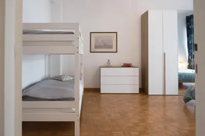 a white bunk bed in a room with a bedroom at Casa Eva - Roma in Rome