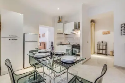 a dining room with a glass table and chairs at Veneto Excelsior Suite in Rome