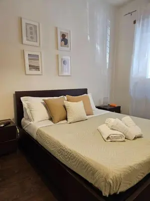 a large bed in a bedroom with two pillows at St Peter central apartment in Rome