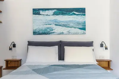 a bedroom with a bed and a painting on the wall at BeB Domus Arbenzio San Giovanni Suite in Rome