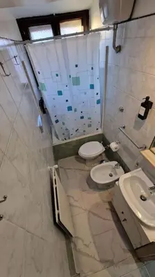 a bathroom with a toilet and a sink at Brik's House in Rome