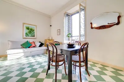 a living room with a table and chairs and a couch at Volturno's Unique View in Rome