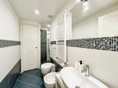 a bathroom with a sink and a toilet and a tub at LA CORTE at the Colosseum in Rome