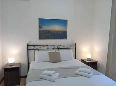 a bedroom with a large bed with two night stands at Vatican Home Borgo Pio II in Rome