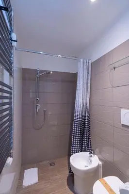 a bathroom with a shower and a toilet and a sink at Sognando Vacanze Romane in Rome