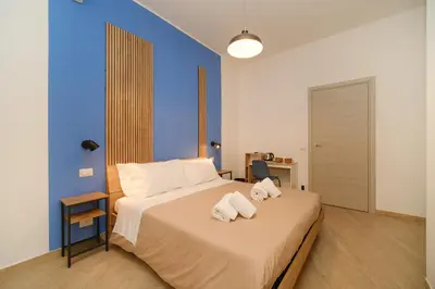 a bedroom with a bed with towels on it at Domus Equi in Rome