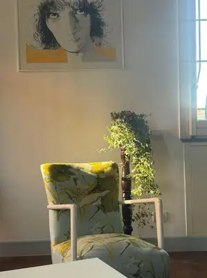 a chair sitting in a room with a plant at Amazing Terrace in Trastevere in Rome