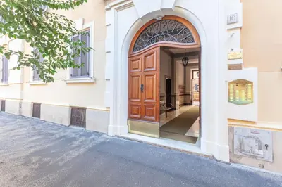 an entrance to a building with a wooden door at Cami Vatican Apartment in Rome