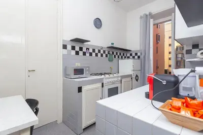 a kitchen with white counters and a stove top oven at Cami Vatican Apartment in Rome