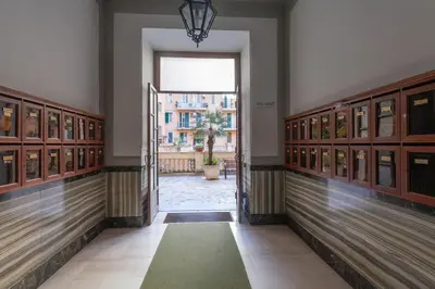 a hallway with an open door in a building at Cami Vatican Apartment in Rome