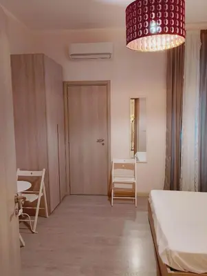 a bedroom with a bed and a table and chairs at San Giovanni Rooms Roma in Rome