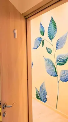 a door with a mural of a plant on it at San Giovanni Rooms Roma in Rome
