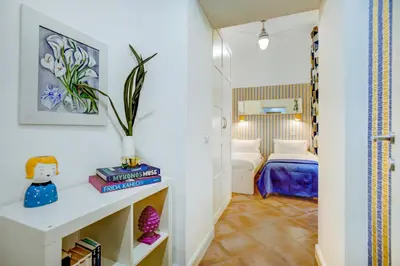 a small room with a bedroom with a bed at Colosseo Families and Groups 2BDR Home and More in Rome