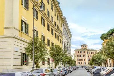 a city street with parked cars and buildings at Colosseo Families and Groups 2BDR Home and More in Rome